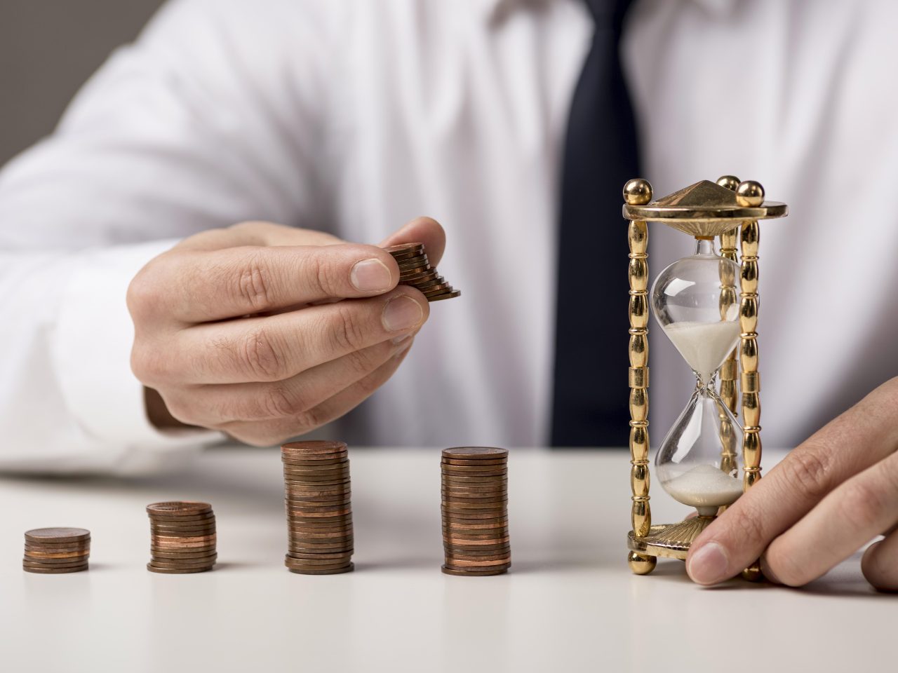front-view-businessman-with-coins-hourglass