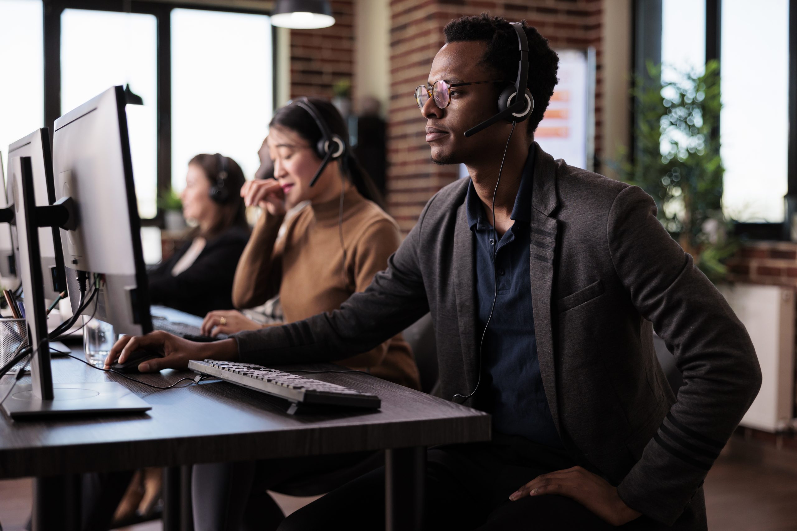 Operator answering client phone call at customer care service